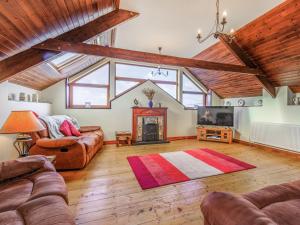 a living room with a couch and a fireplace at The Threshing Barn - Uk35754 in Bideford