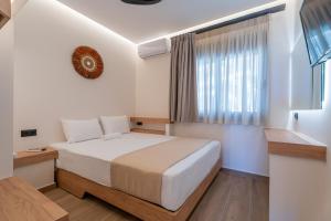 a bedroom with a bed and a window at SithoniaRS Boho Edition Luxury Roofgarden II in Neos Marmaras