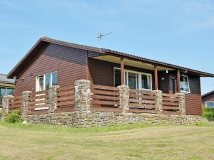 a house with a stone fence in front of it at Hawthorne in Woolfardisworthy