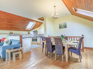 a kitchen and living room with a table and chairs at The Granary - Uk35755 in Bideford