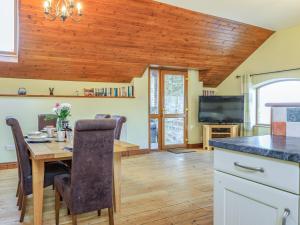 a kitchen and dining room with a wooden ceiling at The Granary - Uk35755 in Bideford