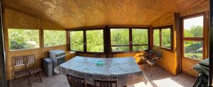 a room with a table in a room with windows at Duna Liget in Dunaföldvár