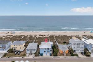an aerial view of a beach with houses and the ocean at SEA2SKY Ocean front private pool and spa in Kure Beach