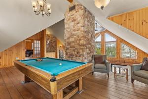 a pool table in a room with a brick wall at Private Pool - Spa - Pool Table - Le St-Come in Saint Come