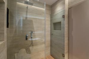 a bathroom with a shower with a sink in it at SithoniaRS Boho Edition Luxury Roofgarden II in Neos Marmaras +103 photos