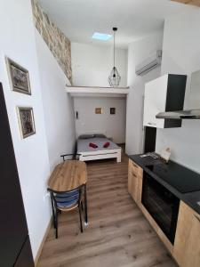 a kitchen with a table and a bed in a room at Tre sorelle in Piran +7 photos