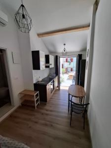 a kitchen with a table and a dining room at Tre sorelle in Piran