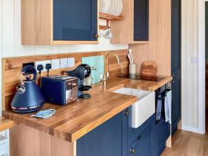 a kitchen counter with a tea kettle and a sink at Walkeridge Farm in Reading