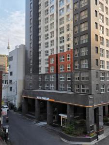 a view of a building next to tall buildings at TRAVELUS Myeongdong 트래블어스 명동 in Seoul