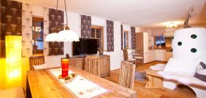 uma sala de estar com uma mesa de jantar e uma sala de estar com um robô em Chalet sTyrolia em Sölden