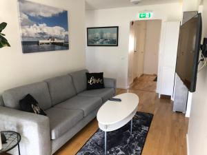 a living room with a couch and a table at Mysiga Villan in Borgholm