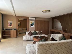 a living room with two couches and a table at RS Hôtel Karam Resort in Ouarzazate
