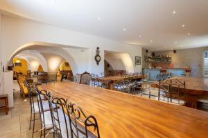 a large room with a large wooden table and chairs at La Grange D'anthounin in Redortiers