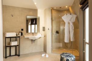 a bathroom with a shower and a sink at Hotel Le 10 BIS in Paris +43 photos