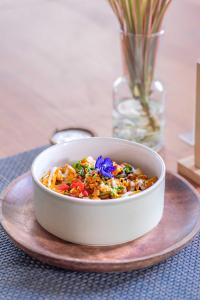 a bowl of food on a plate on a table at Bale Sampan Boutique Bungalows in Gili Trawangan +72 photos