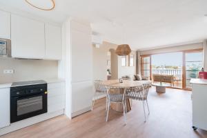 a kitchen and dining room with a table and chairs at CARABELA 92 in Alcudia