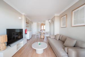 a living room with a couch and a table at CARABELA 92 in Alcudia