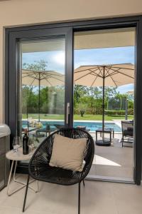 a patio with a chair and a table and umbrella at Casa Presika- Wellness, Fiber Net & Peace in Labin +34 photos