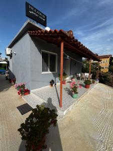 a small building with a sign on top of it at Erik Studio in Ksamil +3 photos