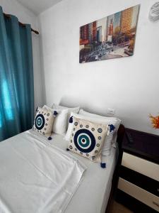 a bedroom with a bed with white sheets and pillows at Erik Studio in Ksamil