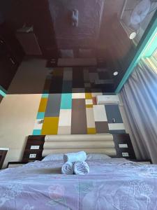 a bedroom with a bed with two towels on it at Orbi Residence in Itʼkhvisi