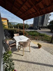 a patio with a table and chairs under a roof at Erik Studio in Ksamil