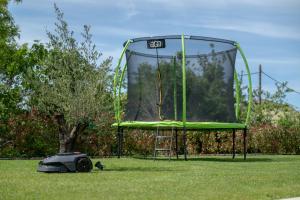 a trampoline and a cat in front of a hoop at Casa Presika- Wellness, Fiber Net & Peace in Labin
