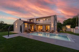 a house with a swimming pool in the yard at Casa Presika- Wellness, Fiber Net & Peace in Labin