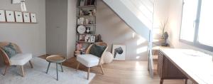 a living room with two chairs and a table at Maison centre-ville, Vue château, Hellfest, Clisson in Clisson