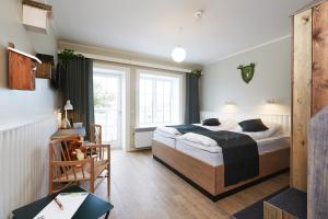 ein Schlafzimmer mit einem großen Bett und einem Fenster in der Unterkunft Hotel Fårup in Blokhus