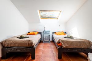 two beds in a room with a window at La Grange D'anthounin in Redortiers +35 photos