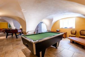 a pool table in a room with arches at La Grange D'anthounin in Redortiers