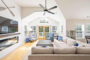 a living room with a couch and a fireplace at Oceanside retreat with pool & spa June Weeks Open in Sanderling
