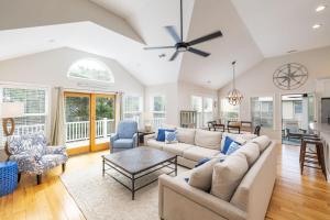 a living room with a couch and a table at Oceanside retreat with pool & spa June Weeks Open in Sanderling