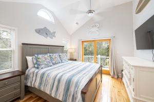 a bedroom with a bed and a window at Oceanside retreat with pool & spa June Weeks Open in Sanderling