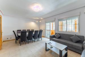 a living room with a couch and a table and chairs at Semi-detached Hse in Loeches