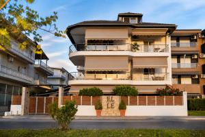 an apartment building with balconies on a street at ELLE Rooms & Suites in Paralia Katerinis