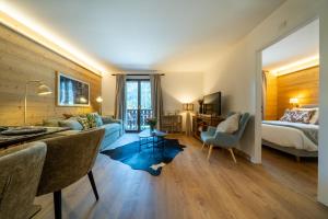 a hotel room with a bed and a living room at Balmoral in Champéry