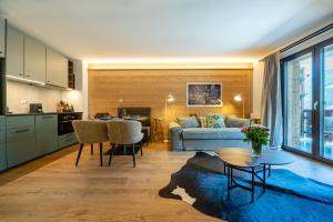 a kitchen and living room with a couch and a table at Balmoral in Champéry