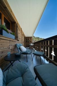 a living room with couches and tables on a balcony at Balmoral in Champéry