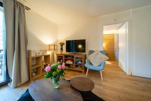 a living room with a vase of flowers on a table at Balmoral in Champéry
