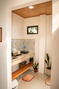 a kitchen with white walls and wood ceilings at Pahuway - Comfort and style in Moalboal +8 photos