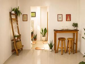 a room with a table and stools in it at Pahuway - Comfort and style in Moalboal