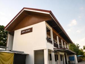 a large white building with a sign on it at Pahuway - Comfort and style in Moalboal