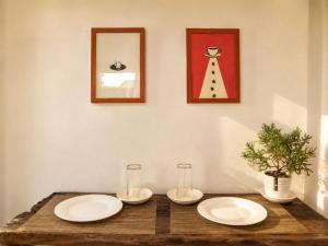 two white plates sitting on a wooden table with a mirror at Pahuway - Comfort and style in Moalboal