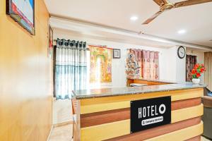 a kochi store with a sign on a counter at Hotel O Anantapur in Anantapur