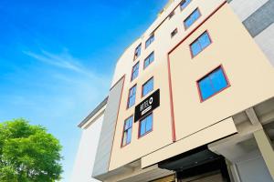 a building with a one way sign on it at Hotel O Anantapur in Anantapur