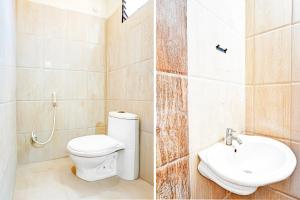 a bathroom with a toilet and a sink at Hotel O Anantapur in Anantapur