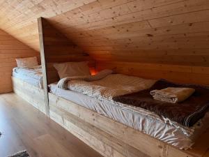 two twin beds in a wooden room with at Bergsbo Lodge in Halmstad