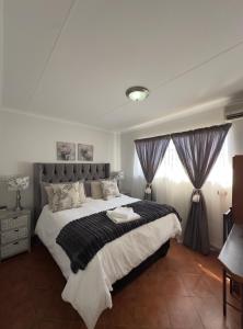 a bedroom with a large bed in a room at Anja Guesthouse in Modimolle